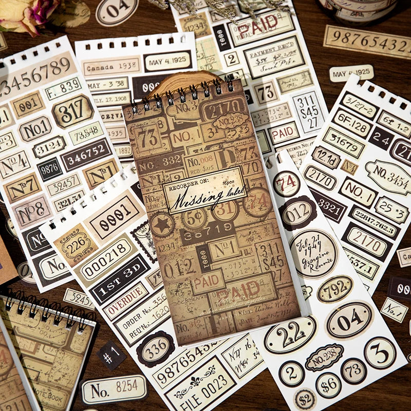 A close-up view of a vintage label sticker book filled with various aged and historical-themed labels for scrapbooking.