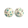 Two round silicone beads with a light background decorated with small turquoise and silver prints