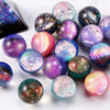 Assorted rubber bouncy balls in various iridescent and glitter colors scattered on a white surface