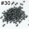 A pile of 1000 small, cylindrical fuse beads in assorted dark gray and black colors.
