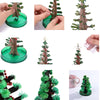 A crystal growing tree science kit showing a miniature tree with blooming red crystals on a green base.