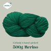 A ball of dark green Merino wool yarn labeled Lirisnly