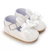 White lace-trimmed baby girl moccasin shoes with bows