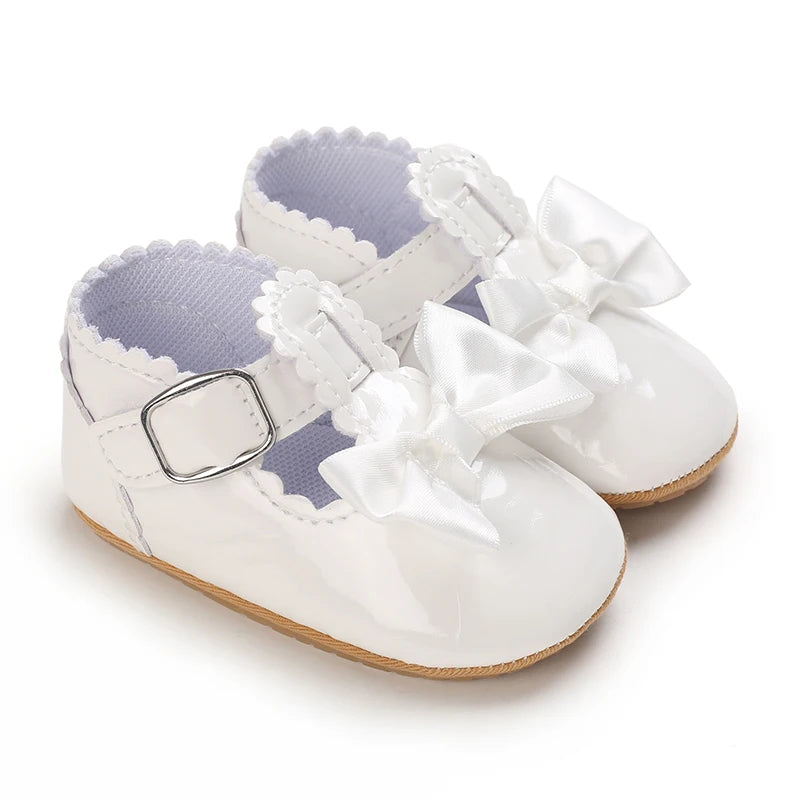 White lace-trimmed baby girl moccasin shoes with bows