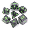 A set of black acrylic dice showing various numbers and shapes like triangles and dodecahedrons.