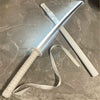 A white luminous anime katana with an LED blade resting on a gray surface.