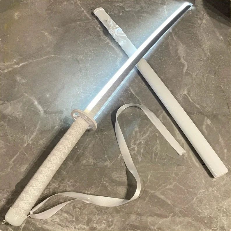 A white luminous anime katana with an LED blade resting on a gray surface.
