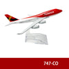 A diecast model of an Avianca airplane in red and white livery, mounted on a clear stand.