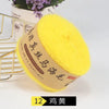 A ball of bright yellow mohair yarn is displayed next to a gold wire rack.