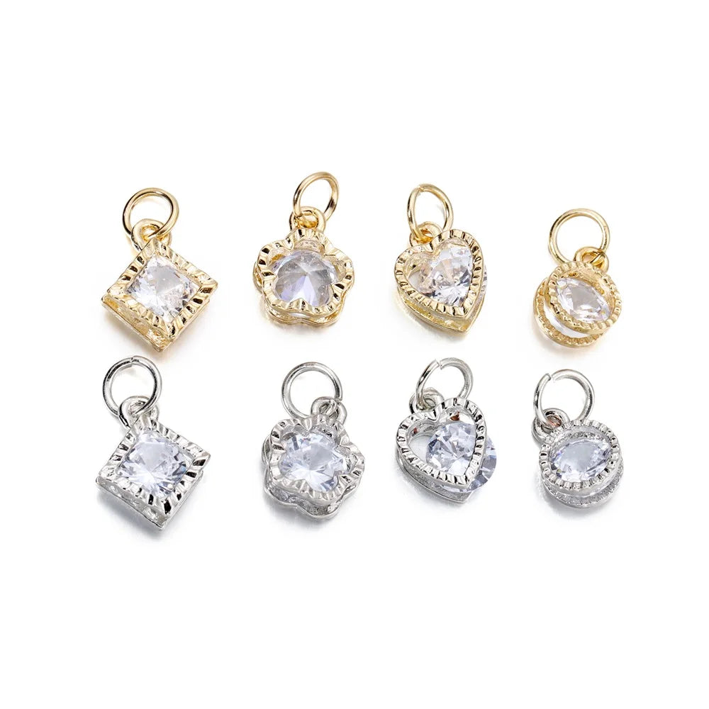 A set of gold and silver rhinestone heart charms for jewelry making.