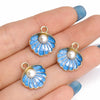 Gold-toned enamel marine life charms featuring blue and white scales and pearl accents