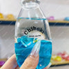 A hand holds a clear glass bottle filled with blue liquid and ice cubes, labeled Chiboki drink cup toy.