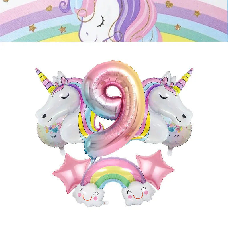 A pink and purple unicorn balloon decoration with a rainbow arch and star accents for a birthday party.