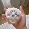 A hand holds a white fluffy plush keychain set featuring three cute animal faces.