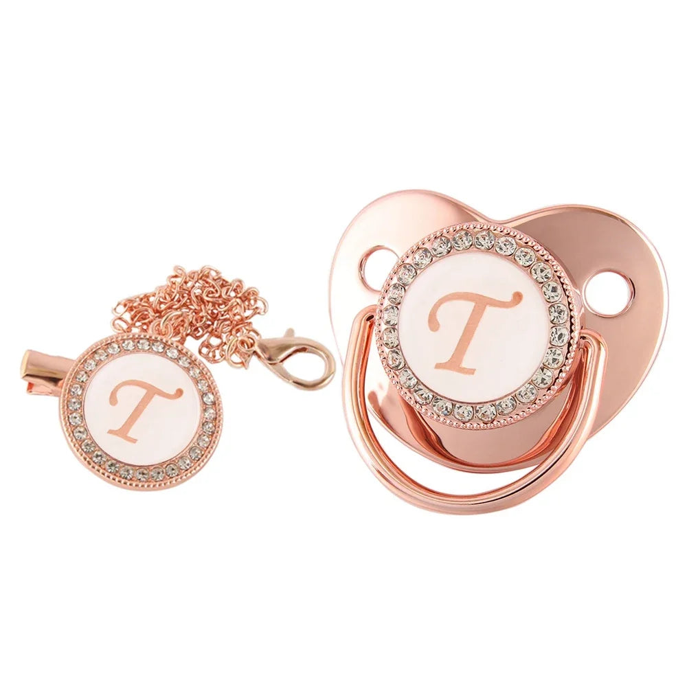 Rose gold bling baby pacifier clip featuring a silicone holder and a decorative letter T