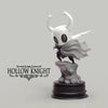 A white Hollow Knight Little Knight handcrafted PVC figure statue with a flowing cape on a black base.