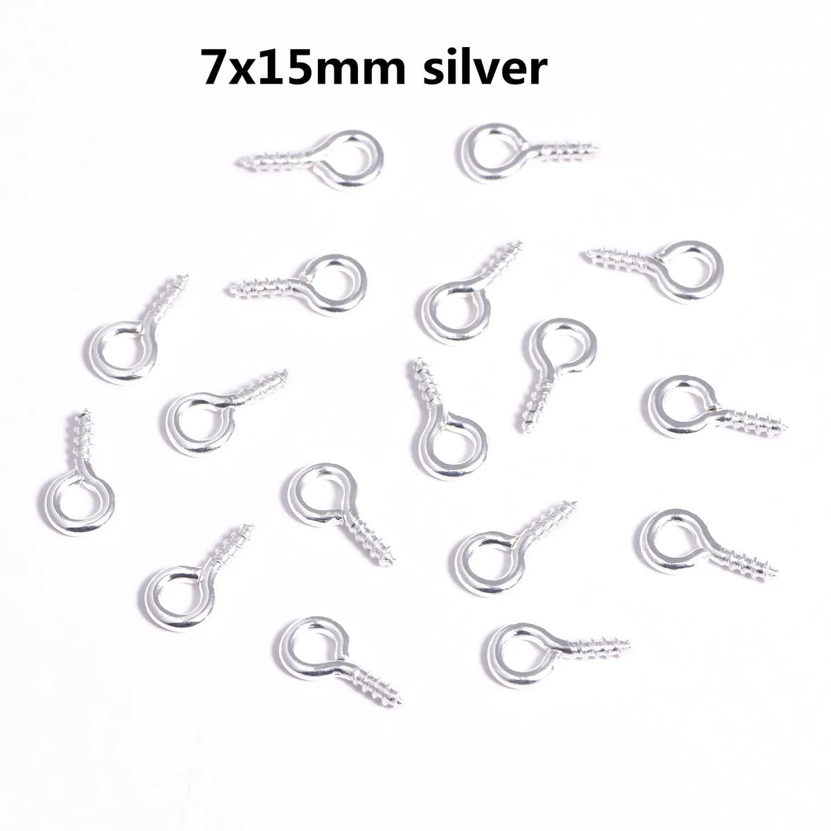 A collection of silver mini eye pins with screw threads for jewelry making.