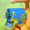 A bright blue electric bubble machine toy is held by a stylized, light orange hand against a lime green background.