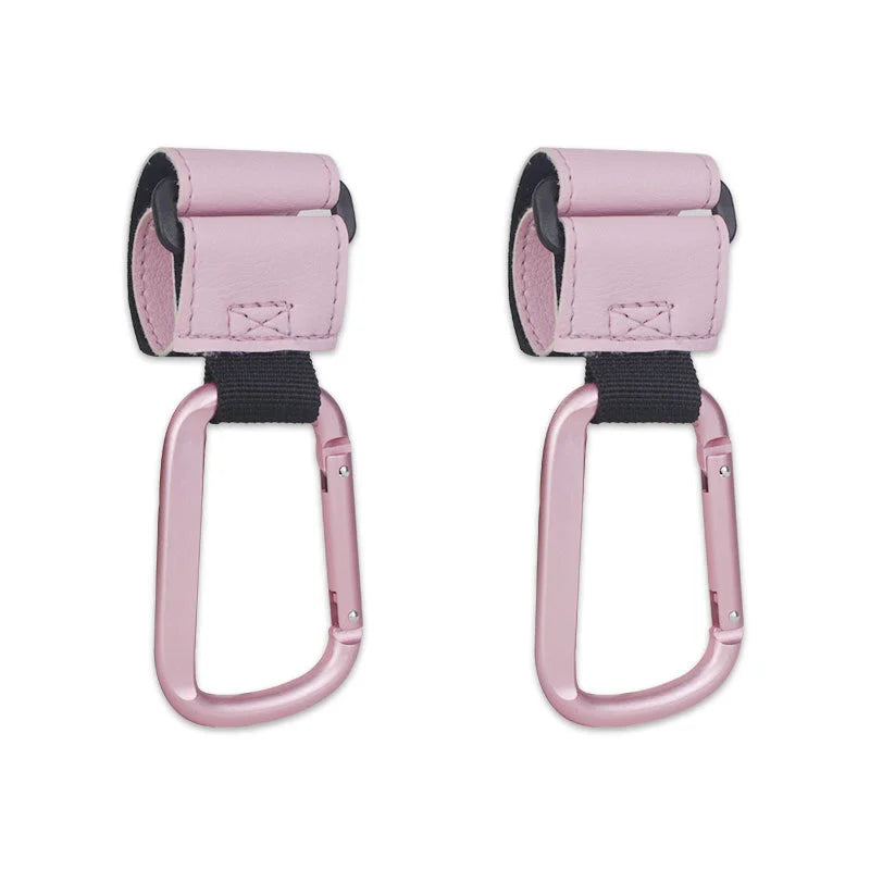 A pair of pink heavy-duty stroller hooks with black straps for hands-free organization.
