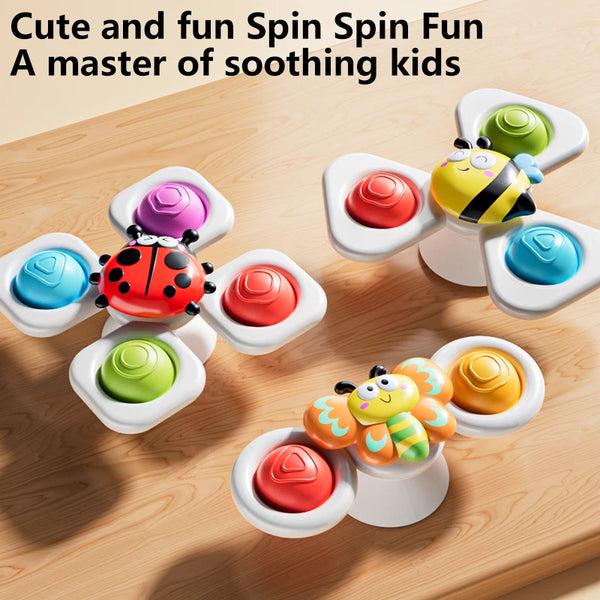 Three spinning top fidget toys featuring insects and colorful watch bands on a wooden surface.