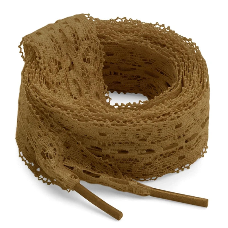 A spool of tan flat elastic silk lace shoelaces coiled on a white background.