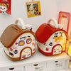An orange house-shaped piggy bank with a lid and key, featuring a yellow cartoon dog design.