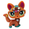 An orange pet figurine resembling a dachshund kitten with sparkly purple and green accents.