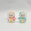 Two cute silicone snowman molds for crafts, one pink and one blue, displayed against a white background.