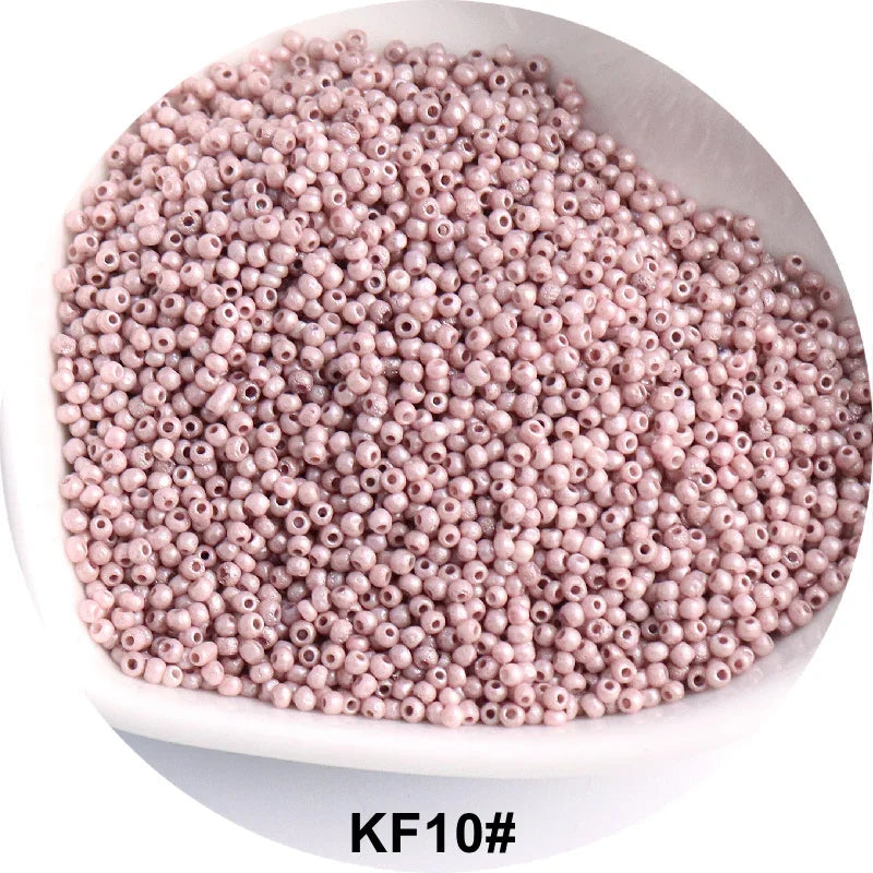 A pile of pink glass seed beads, identified as KF10#, is shown in a white dish.