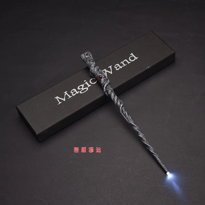 A dark wooden box holds a twisted, silver LED light-up magic wand resting diagonally on the surface.