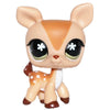 A small, tan bobblehead toy of a deer with large black eyes and white markings.