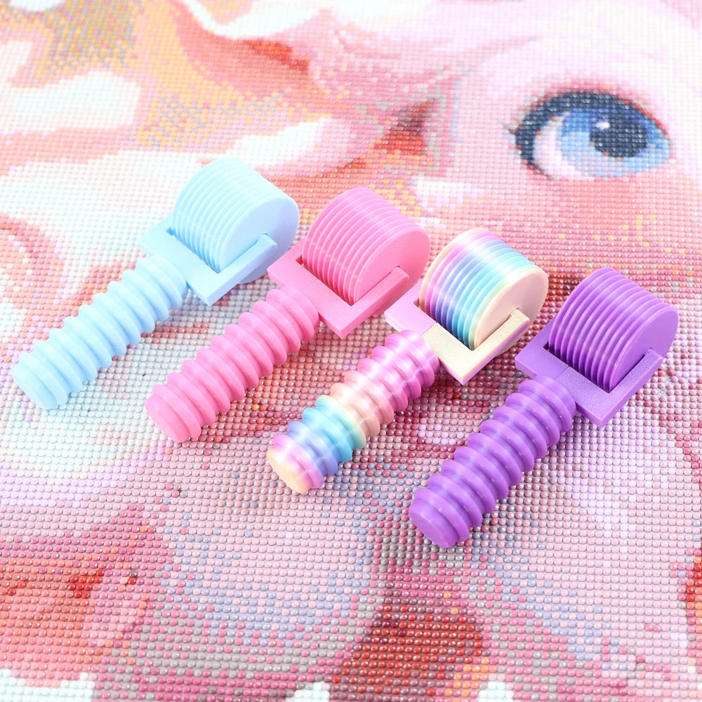 A collection of pink and purple detachable diamond painting rollers are displayed on a pink and white background.