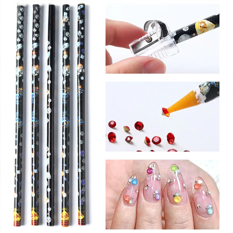 A hand holds a clear plastic pen with a black grip used to pick and apply rhinestones onto nails.