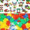 A colorful mosaic of red, yellow, green, and blue snowflake-shaped building blocks for children.