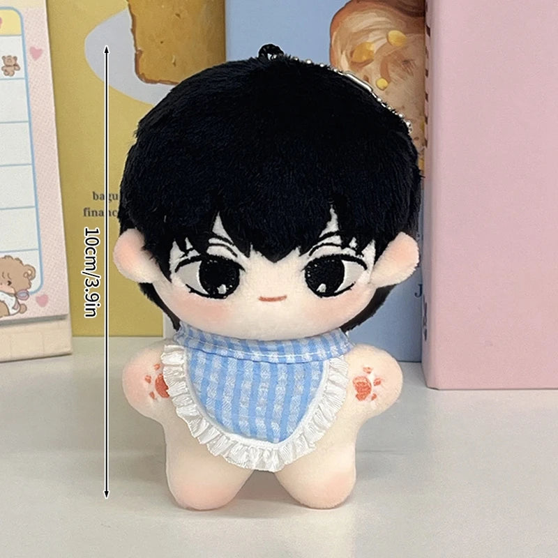 A black-haired chibi plush keychain of a boy wearing a blue striped bib and a white ruffled collar.