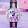 A purple and pink My Little Pony Magic Sweetheart blind box watch with a blue striped strap on a purple surface.