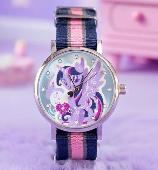 A purple and pink My Little Pony Magic Sweetheart blind box watch with a blue striped strap on a purple surface.