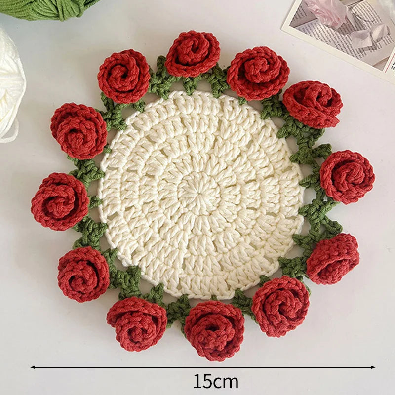 Hand-crocheted red and green lily of the valley coasters featuring a white textured center