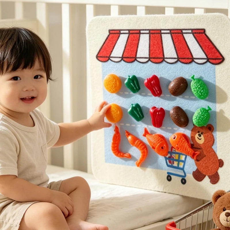 A baby is interacting with a felt board featuring colorful fruits and vegetables for pretend play.