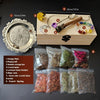 A witchcraft starter kit displayed with a wooden box containing crystals, herbs, and a silver plate.