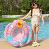A smiling girl holds a pink inflatable aircraft swim ring filled with colorful toys on a poolside.
