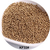 A pile of gold-colored seed beads in a white bowl.
