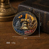 A round lapel pin featuring the Statue of Liberty and an eagle, set against a patriotic background.