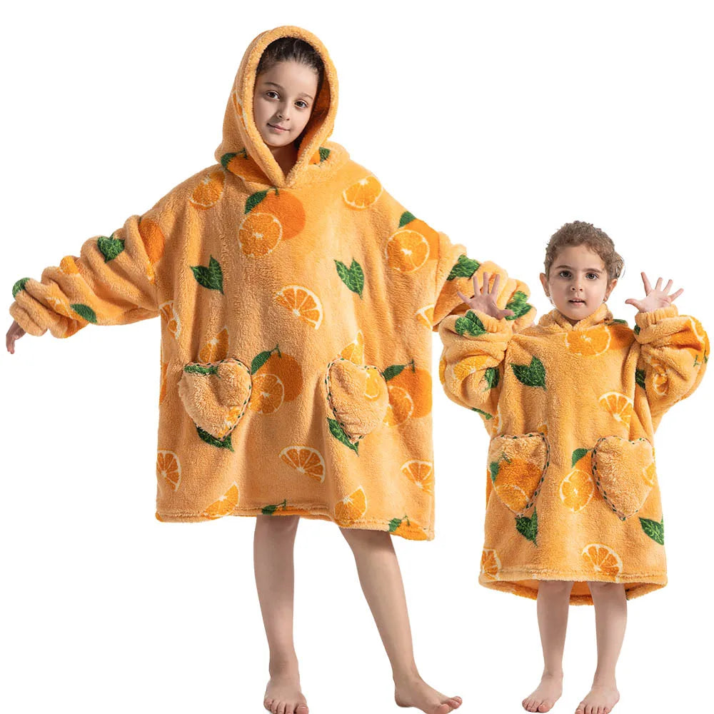 A young girl and boy wearing matching orange flannel hooded sweaters for winter.