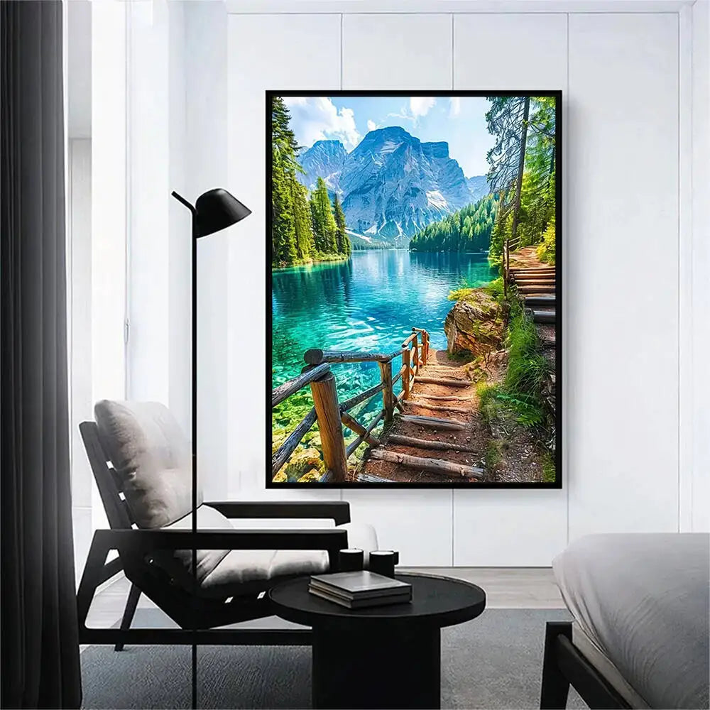 A framed painting of a scenic mountain lake with lush green trees and rugged cliffs.