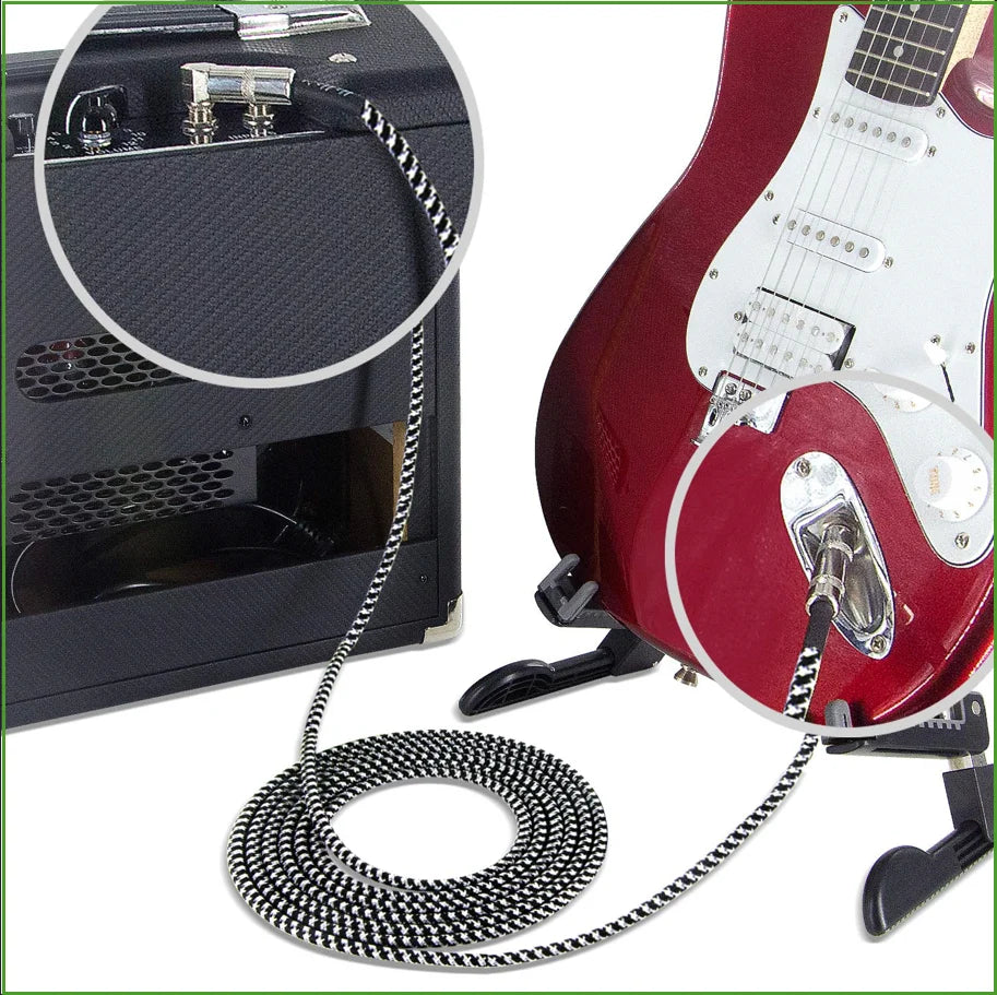A red electric guitar is shown with a professional instrument cable connected to it.