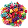 A pile of mixed colored acrylic letter beads in various shapes and sizes for DIY crafts