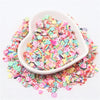 A white dish filled with colorful polymer clay sprinkles for slime and craft decor