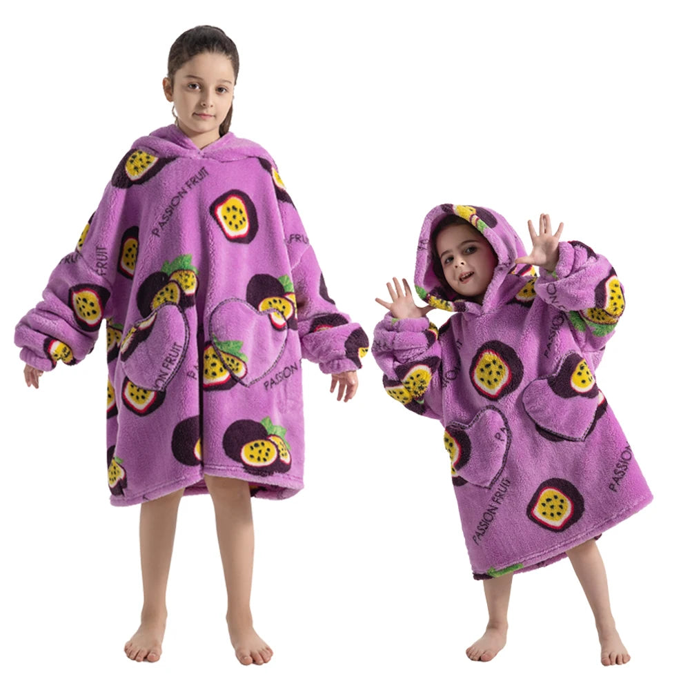 A young girl models a purple passion fruit print cozy kids flannel hoodie sweater.