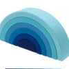 A set of soft silicone rainbow building blocks in shades of blue and cyan, shown at an angle.